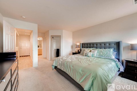 A bedroom with a large bed and a dresser.