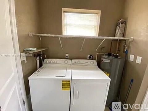 A small laundry room with a washer and dryer.