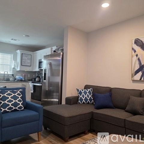 A living room with a grey couch and a blue chair.