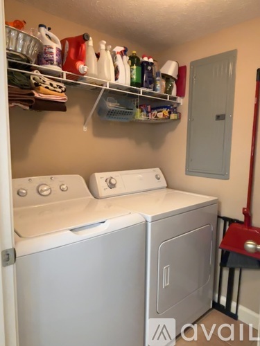 A small laundry room with a washer and dryer.