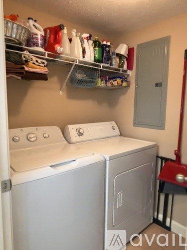 A small laundry room with a washer and dryer.