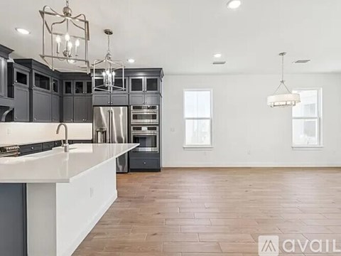 A modern kitchen with dark wood cabinets and a white countertop.