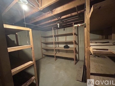 A room with wooden shelves and a hanging light fixture.