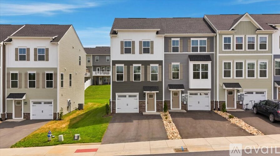 A row of houses with garages in front of them.