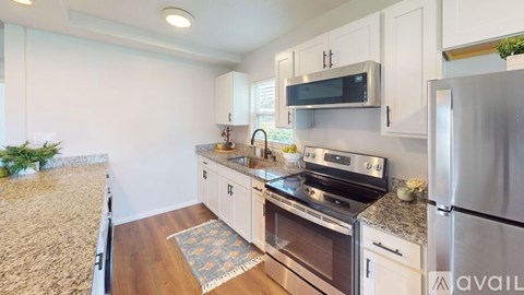 A kitchen with a stove top oven and a refrigerator.