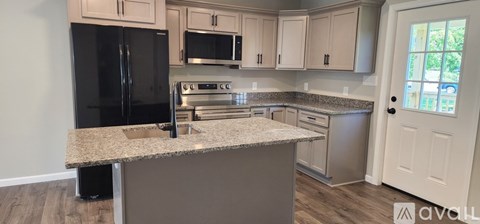 A kitchen with granite countertops and stainless steel appliances.