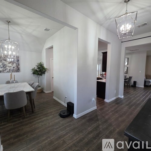 A modern living room with a dining table and chairs.