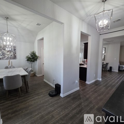 A modern living room with a dining table and chairs.