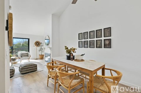 A dining room with a wooden table and chairs.