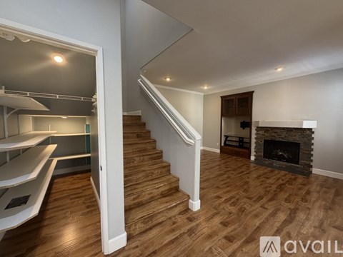 A modern living room with a staircase leading to the upper floor.