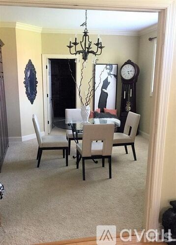 A dining room with a table set for four.