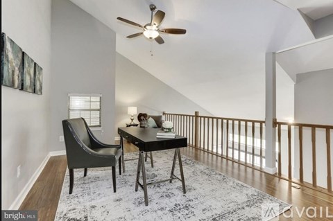 A dining room with a table and chairs.