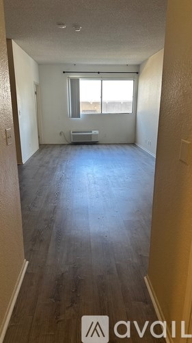 A room with a window and a bench in it.