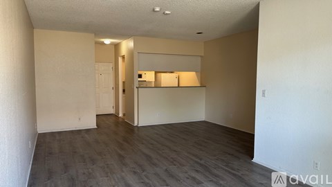 A spacious room with a white door and a countertop.