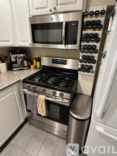A kitchen with a stove, microwave, and refrigerator.