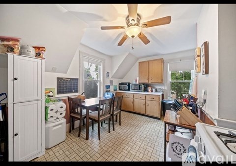 A kitchen with a table and chairs in the middle of the room.