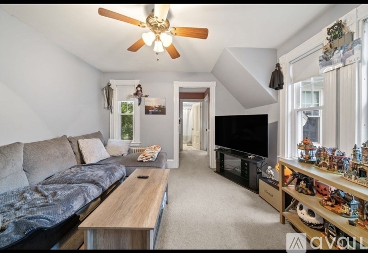 A living room with a grey couch and a wooden coffee table.