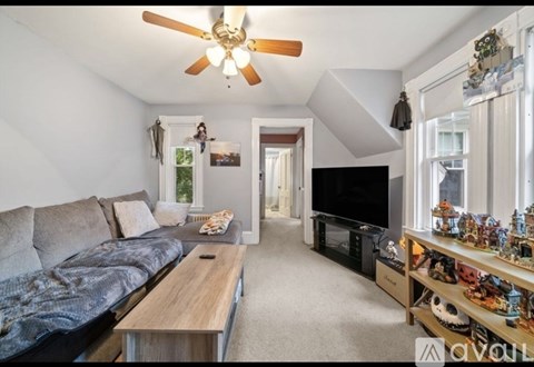 A living room with a grey couch and a wooden coffee table.
