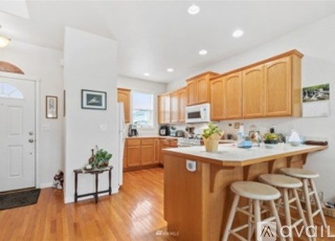 A kitchen with wooden cabinets and a white island.