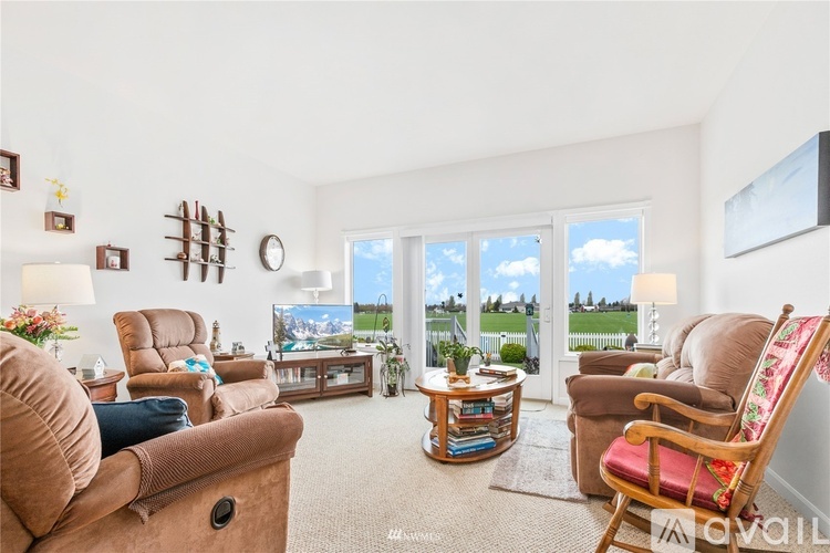 A living room with a large window and a view of the outside.