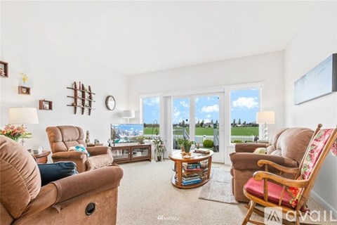 A living room with a large window and a view of the outside.