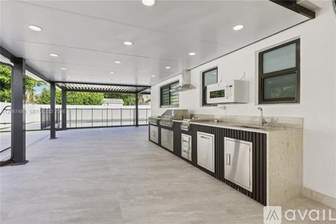 A spacious kitchen area with a long counter and modern appliances.