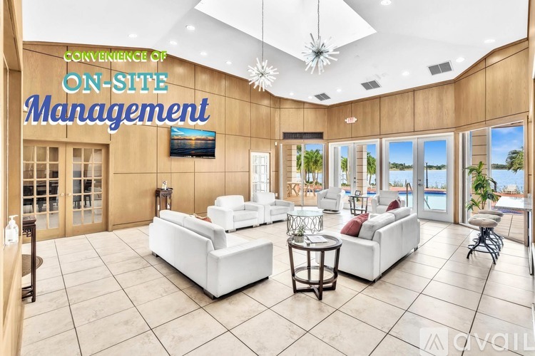 A spacious living room with a sign that reads "CONVENIENCE OF ON-SITE MANAGEMENT" and a view of the outdoors through the windows.