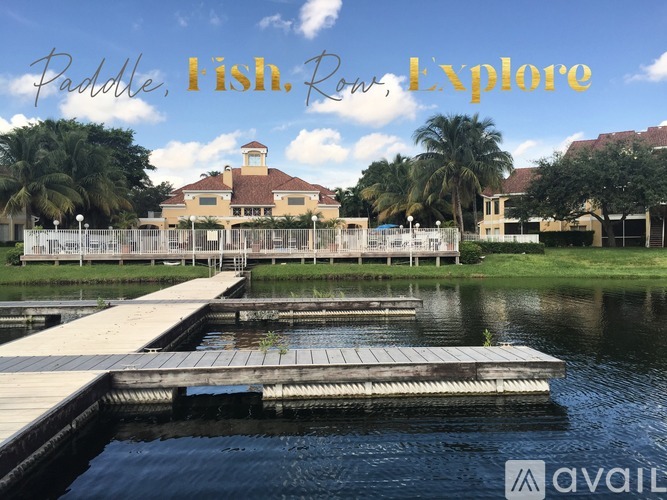 A docked boat with a building in the background and the words "Paddle Fish Row Explore" written on the image.