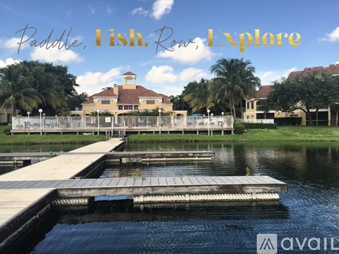 A docked boat with a building in the background and the words "Paddle Fish Row Explore" written on the image.
