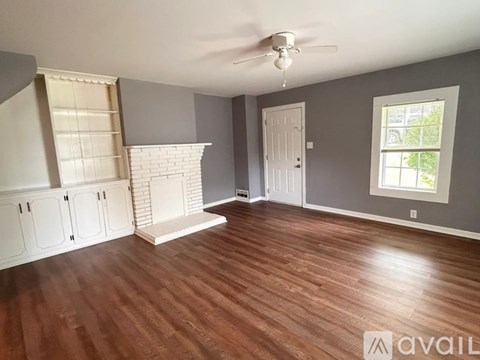 A room with a fireplace and a window.
