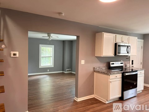A kitchen with a stove top oven and microwave.