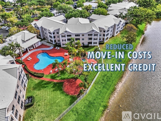 Above view of apartment complex with a pool and text "Reduced Move-in Costs Excellent Credit".