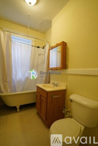 A bathroom with a toilet, sink, and bathtub.