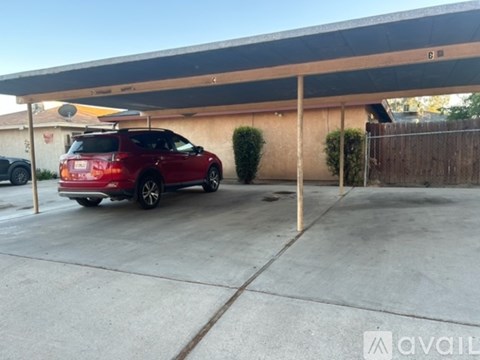 A red car is parked in a garage.