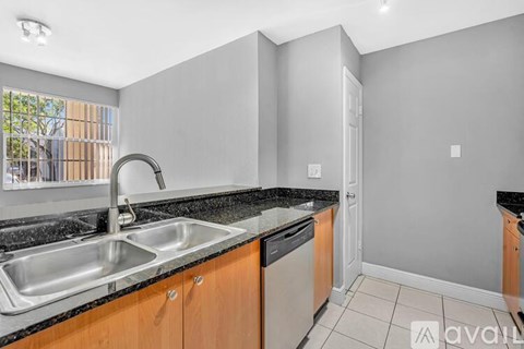 A kitchen with a sink and a window.