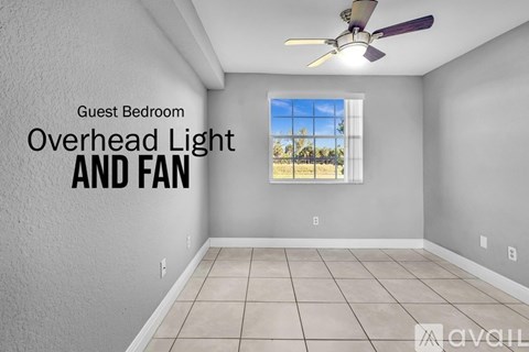 A guest bedroom with an overhead light and fan.