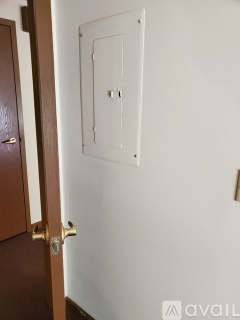 A white door with a handle and a lock on it.