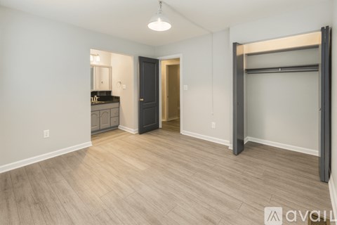 A spacious room with a wooden floor and a large closet.