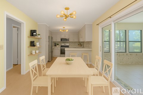 A dining room with a table and chairs is shown.