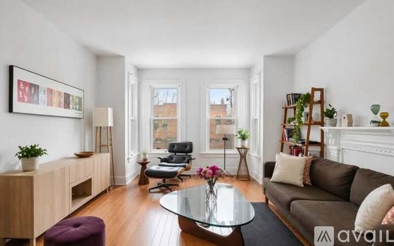 A living room with a couch, chair, and a coffee table.