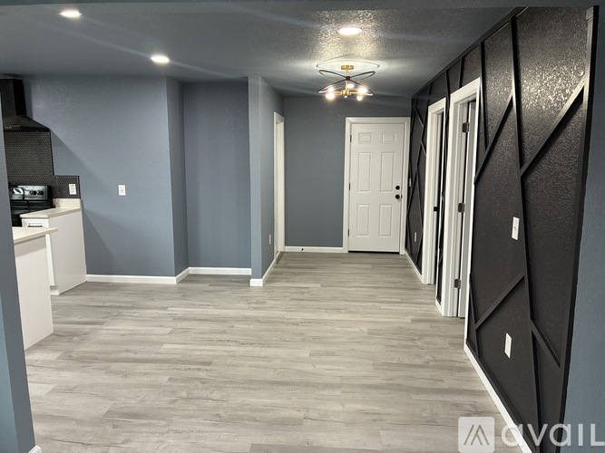 A long hallway with a white door at the end.