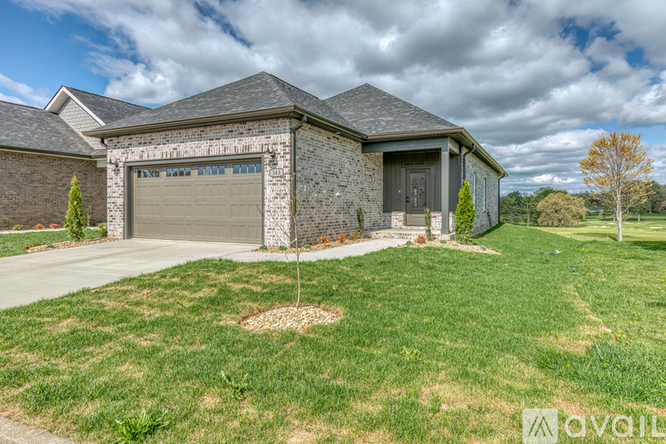 A house with a garage is for sale.