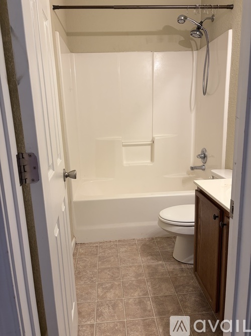 A small white bathroom with a toilet and a bathtub.