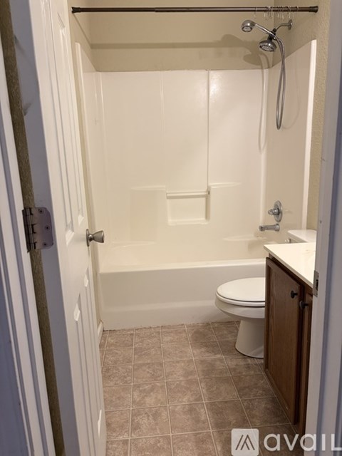 A small white bathroom with a toilet and a bathtub.