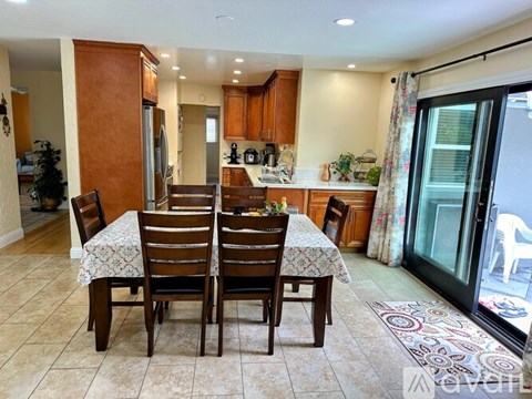 A dining room with a table set for four.
