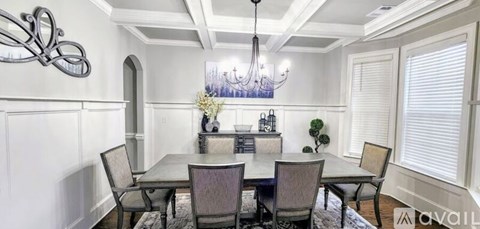 A dining room with a table set for six.