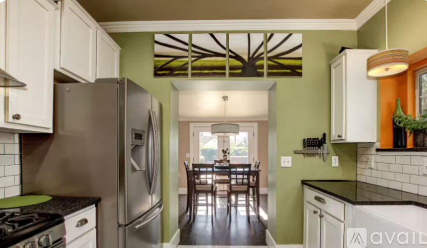 A kitchen with a stove top oven and a refrigerator.