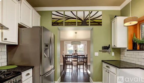 A kitchen with a stove top oven and a refrigerator.