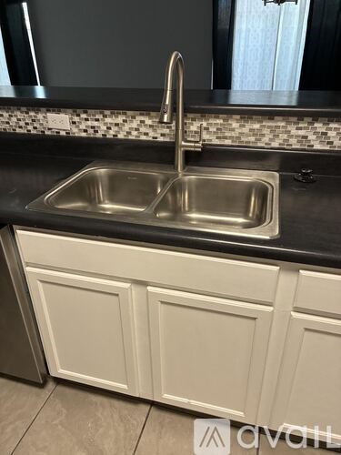 A kitchen sink with a faucet and a countertop.