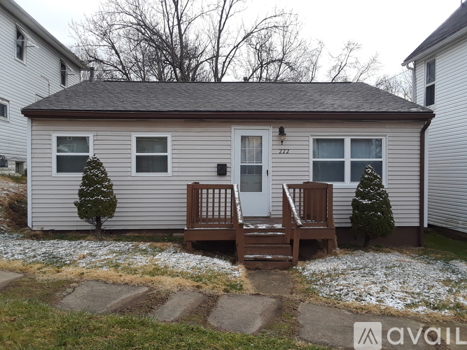 A house with a white door and a brown porch.